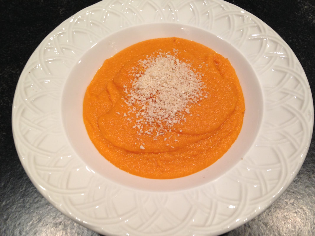 Ginger Carrot Soup with finely grated cashews on top.